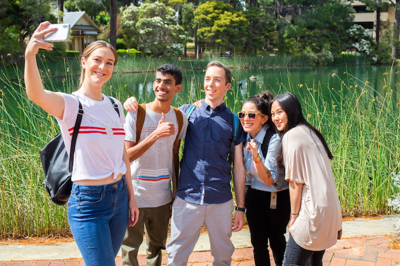 Students taking a selfie in front of ECU Joondalup Campus